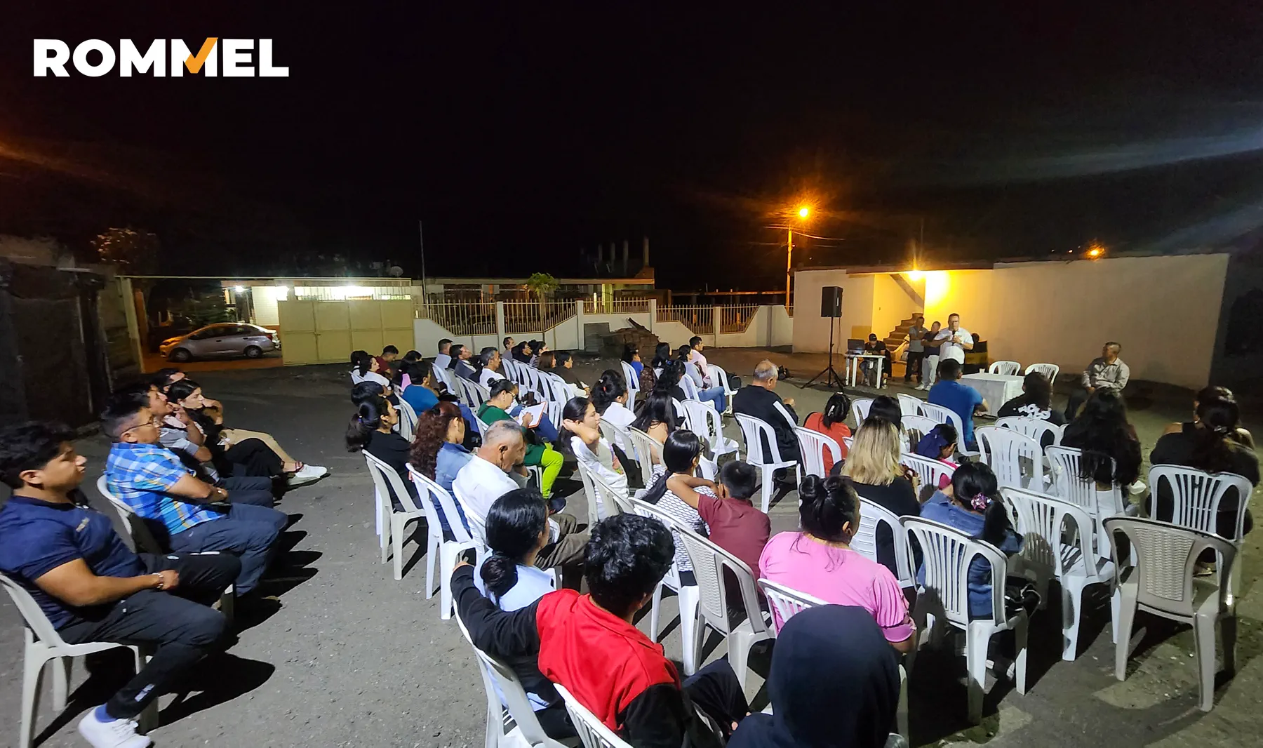 Vista amplia de una reunión comunitaria realizada durante la noche